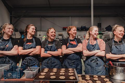 Women bakers in denim aprons in a bakery