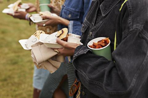 Three people carrying street food items