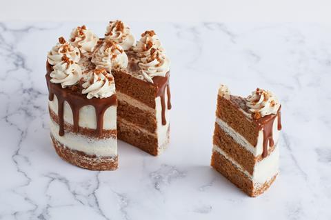 A blonde chocolate layer cake with caramel drip icing and buttercream on top