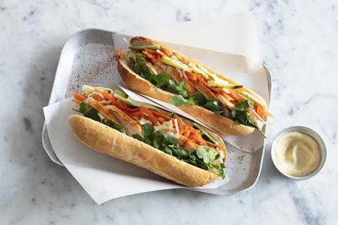 Two Banh Mi sandwiches on a marble tray