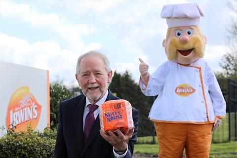 Irwin's Bakery - Former chairman Brian Irwin holds a Nutty Krust loaf with the bakery mascot - 2100x1400