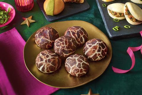 Brown and white steamed mushroom buns on a golden plate