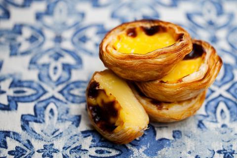 Pastel de natas on a blue tiled background