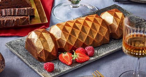 A gold lustred cake, shaped like a Christmas cracker