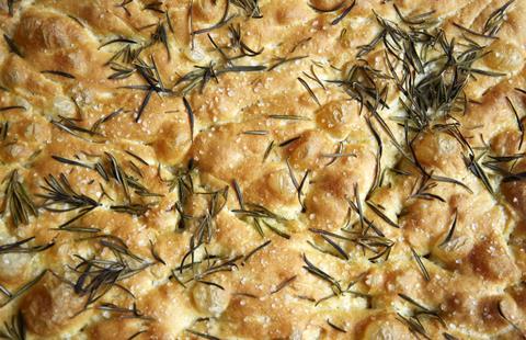 A close-up of a sea salt and rosemary focaccia