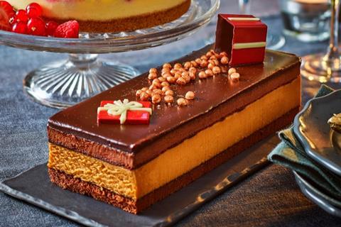 A layered chocolate dessert with edible presents on top