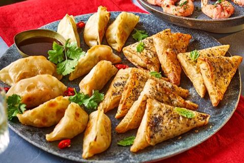 Feta samosas and vegetable gyoza on a blue plate