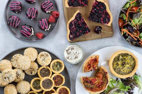 A selection of vegan baked products including fruit tarts and quiches