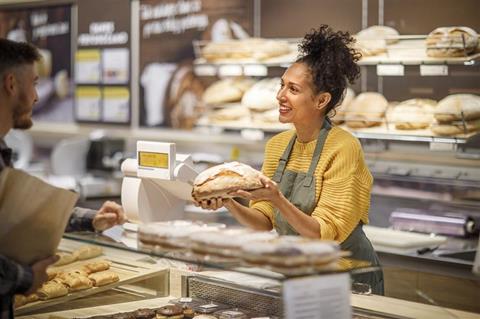 Getty Images -1451382673 woman serving customer at counter credit sanjeri