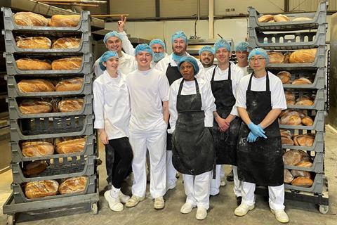 Tom Martin (centre) stands with the production team at The Bread Factory in Manchester  2100x1400