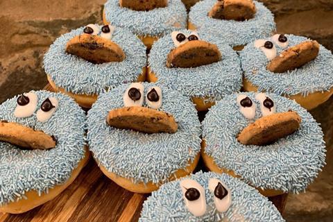 Doughnuts with blue sprinkles, icing eyes and cookies on top