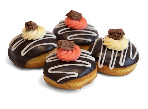 Doughnuts with chocolate icing, cream and flaked chocolate on top