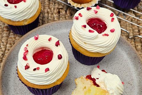 Cupcakes with big swirls of cream and jam on top