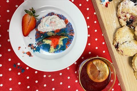 A red, white and blue cupcake with glittery white frosting