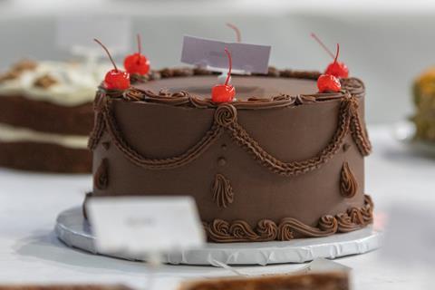A decadent looking chocolate cake with cherry decorations