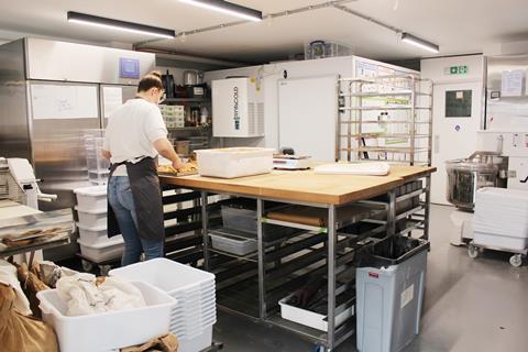 A Gwyn's Bakery staff member preps the cinnamon buns for sales