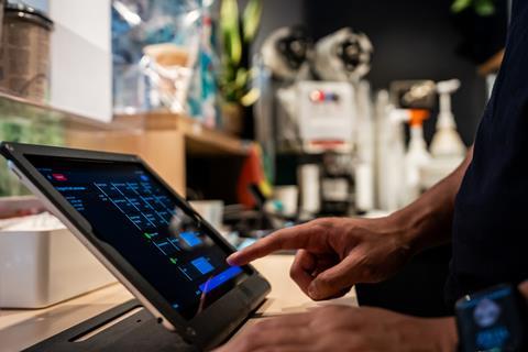 A worker types in an order using Vita Mojo POS software