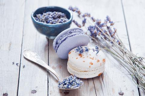 Lavender macarons next to pieces of lavender