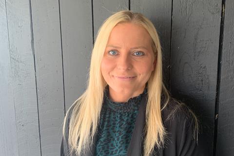 A woman with blonde hair and blue eyes