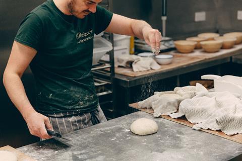 David Le Masurier, founder, Pettigrew Bakeries sprinkling flour onto sourdough