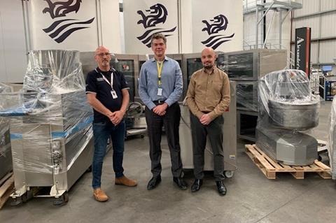 Tesco's AJ Bailey (left) and John Lamper (right) with David Amos from Zeelandia in front of the donated bakery equipment before it was transported to Ukraine