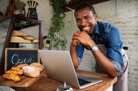 Baker using laptop for online sales