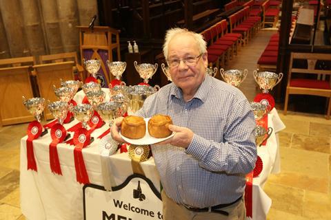 British Pie Awards chairman Dr Matthew O’Callaghan OBE displays some pies in front of the award trophies at St Mary's Church in Melton Mowbray 2100x1400