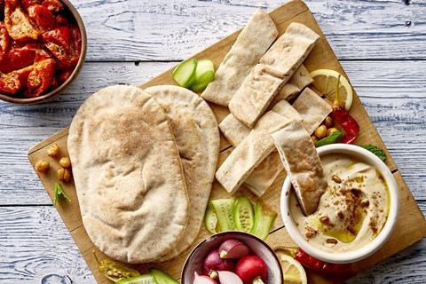 An inviting board with gluten-free pittas and dips on