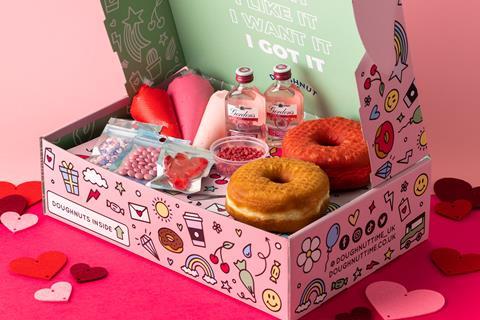 A pink box with doughnut decorating kit inside
