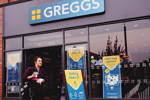 Greggs shopfront with woman walking past