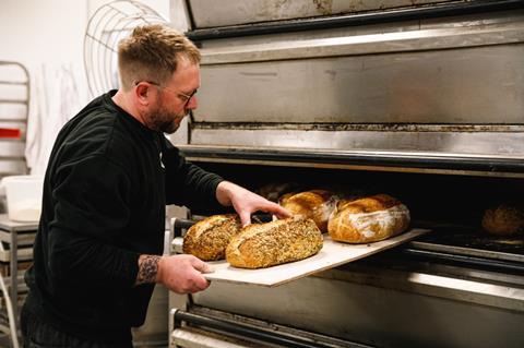 John Jones of Bakehouse at Cakesmiths taking sourdough loaves out of the oven