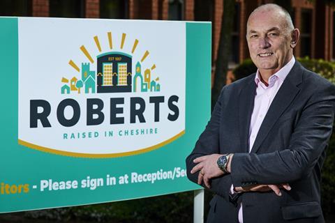 Roberts Bakery MD Bill Thurston stood by a colourful sign that says 'Roberts Bakery'