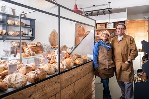 Catherine Connor & Aidan Monks next to a well stocked bakery counter