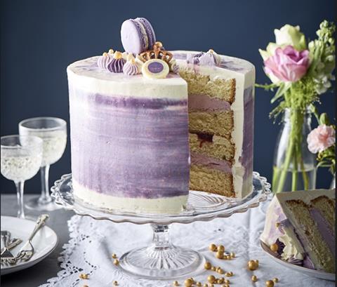 Purple four tier cake with slice taken out of it