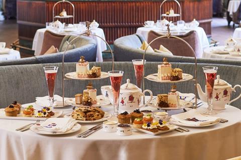 A luxurious afternoon tea with glasses of pink fizz at a theatre in London