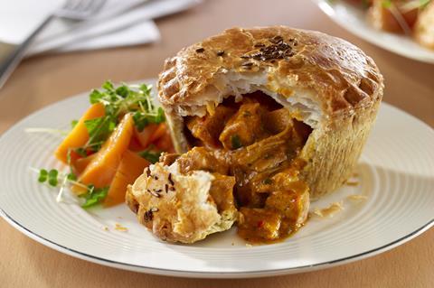Wrights Chicken Balti Pie with filling spilling out in an appetising way