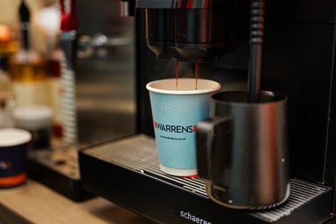 Fresh coffee being poured into a Warrens Bakery branded cup