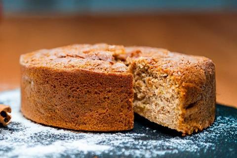 An apple cake dusted with icing sugar