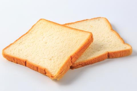 Two slices of white bread on a white backgroun
