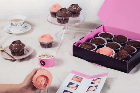 Chocolate cupcakes in a pink box with frosting