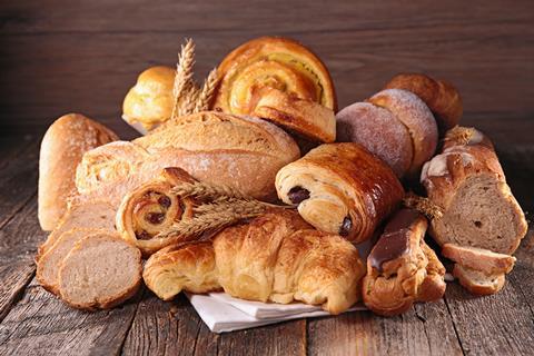 Bread, croissants and doughnuts on a wooden background