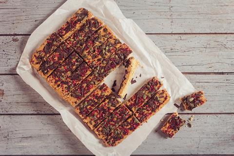 A salted caramel traybake with pumpkin seeds and freeze dried raspberries on top