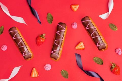 Chocolate eclairs on a red background with ribbons