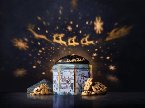 A light up biscuit tin projected reindeer lights onto a dark wall