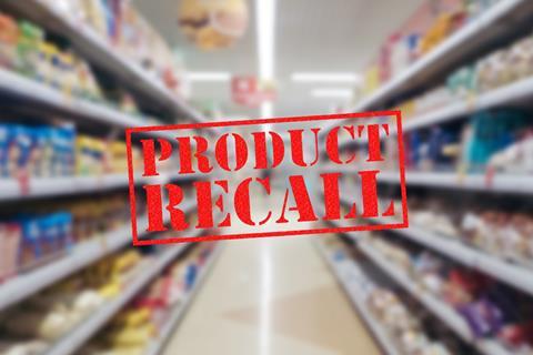 Product recall in red lettering over a blurred image of a supermarket aisle