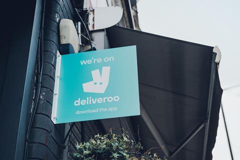 'We're on Deliveroo' sign outside a shop