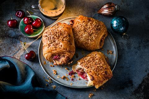 Cherry Stollen Croissants on a blue plate with baubles at the side