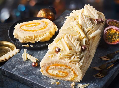 Passionfruit & White Chocolate Yule Log with slices of passionfruit next to it