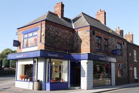 A Waterfields bakery shop against a sunny blue sky