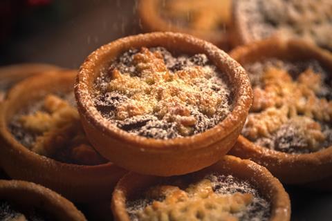 A close-up of Mr Kipling mince pies dusted with icing sugar